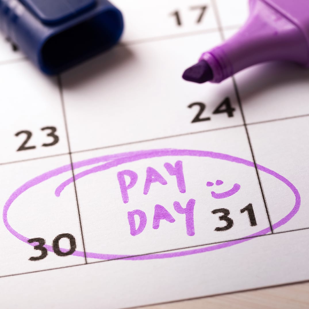 payday concept calendar with marker and circled day of salary