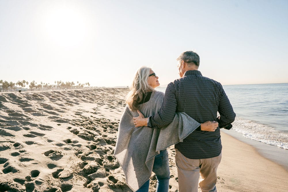 couple taking stroll down beach