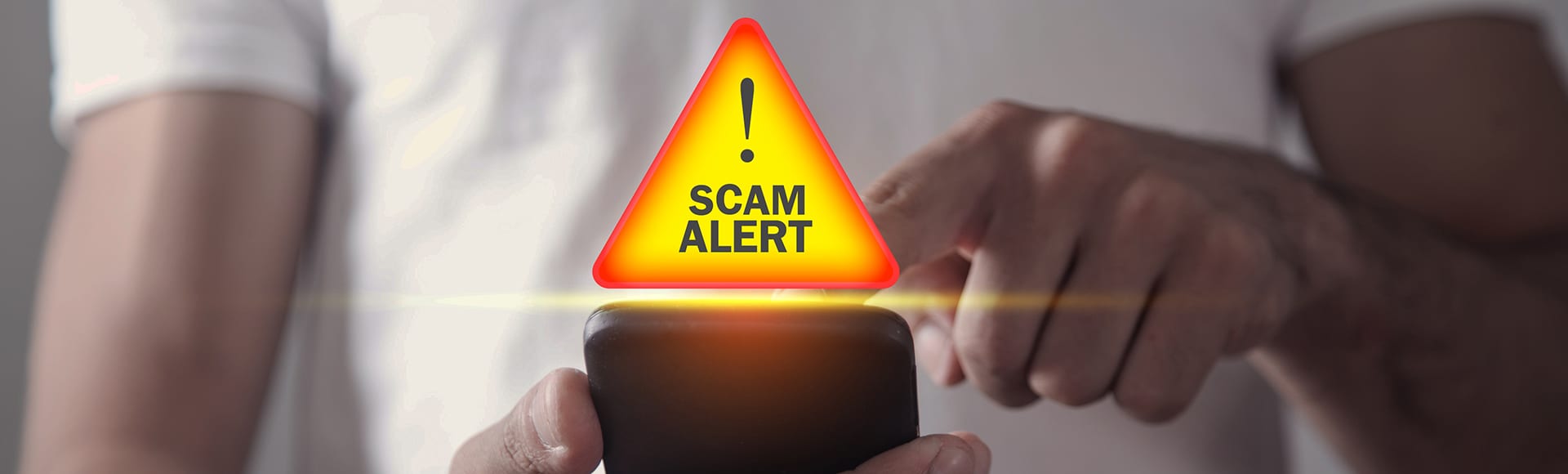 Man holding smartphone. Scam Alert